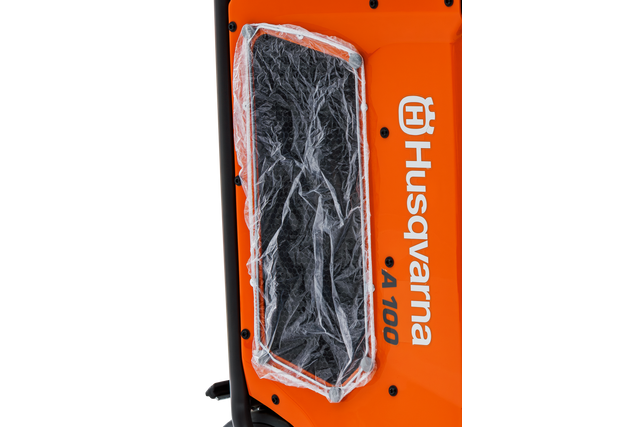 Close-up of a Husqvarna product showing the air filter section covered in protective plastic.