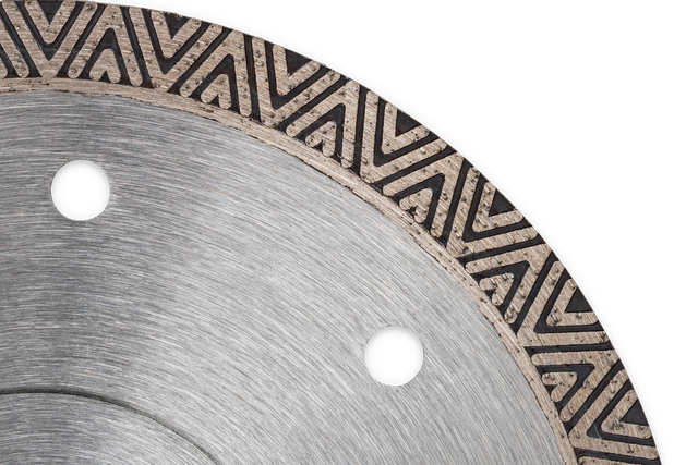 Close-up of a circular saw blade with a patterned edge.