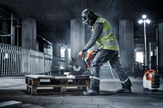 Construction worker sawing stone with K 1 Pace