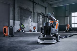 Autogrinder operator with single disc grinder, dust extractor and air cleaners