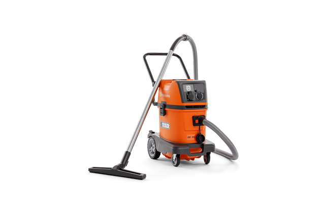 Side view of a Husqvarna industrial vacuum cleaner with hose and floor nozzle.